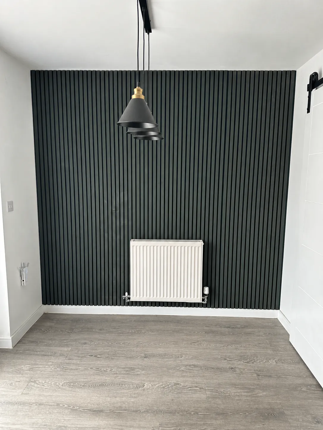 Dark slat feature wall in dining room