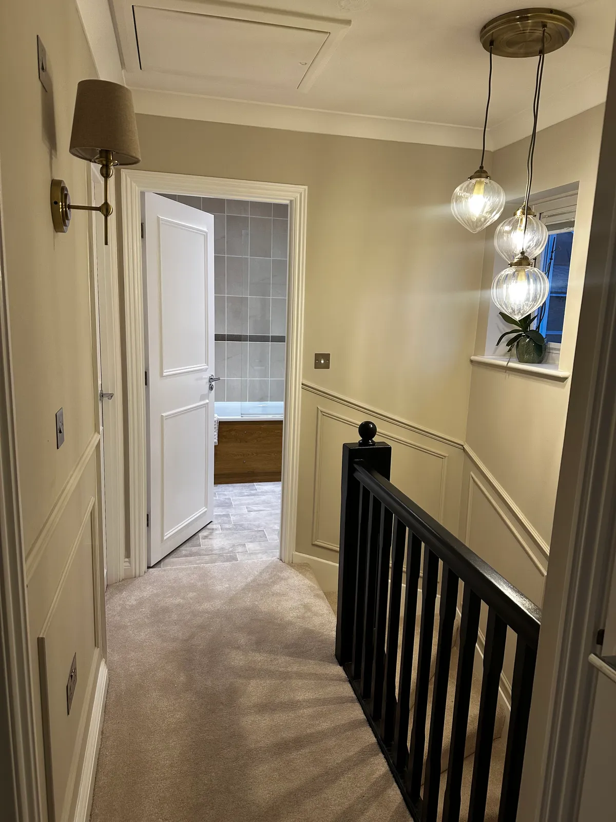 Panelled landing with brass pendant lights